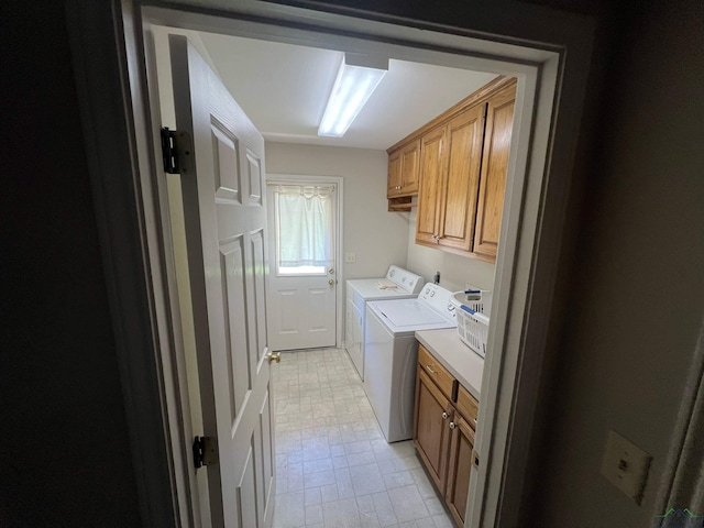 laundry room featuring cabinets and separate washer and dryer