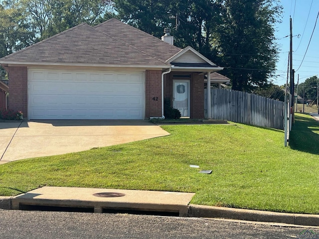 view of front of home featuring a front yard and a garage