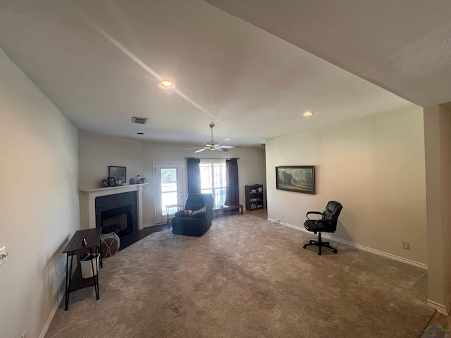 sitting room featuring carpet and ceiling fan