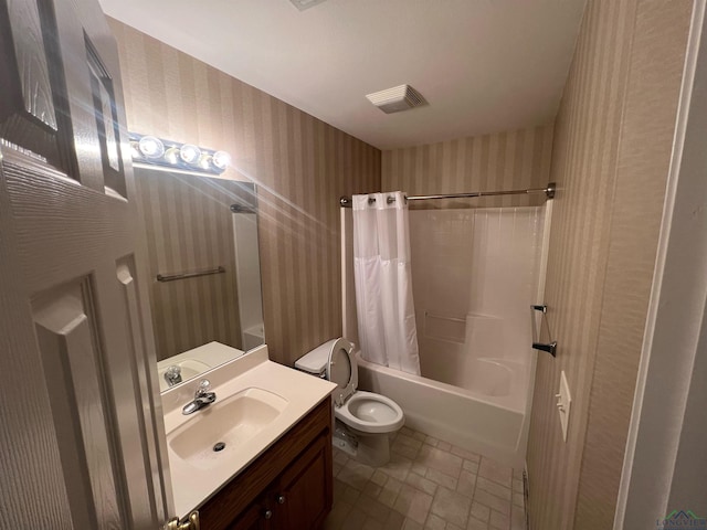 full bathroom with vanity, shower / tub combo, and toilet