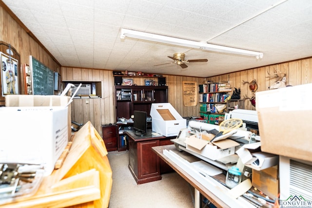 office space with ceiling fan and wooden walls