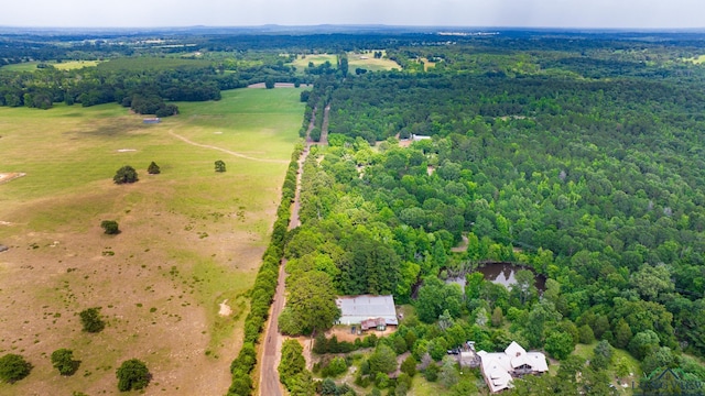 drone / aerial view featuring a wooded view and a rural view