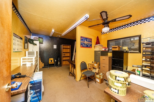 interior space with a textured ceiling, a ceiling fan, and carpet flooring