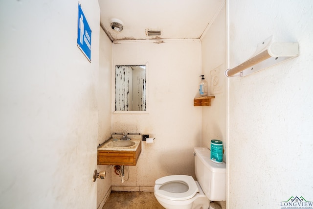 bathroom with visible vents, a sink, and toilet