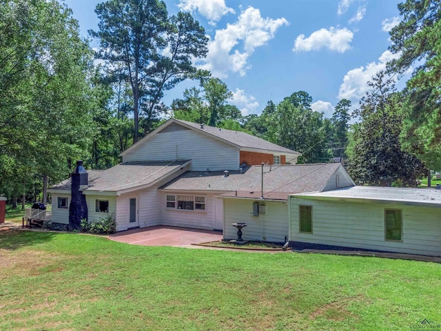 rear view of house with a yard and a patio