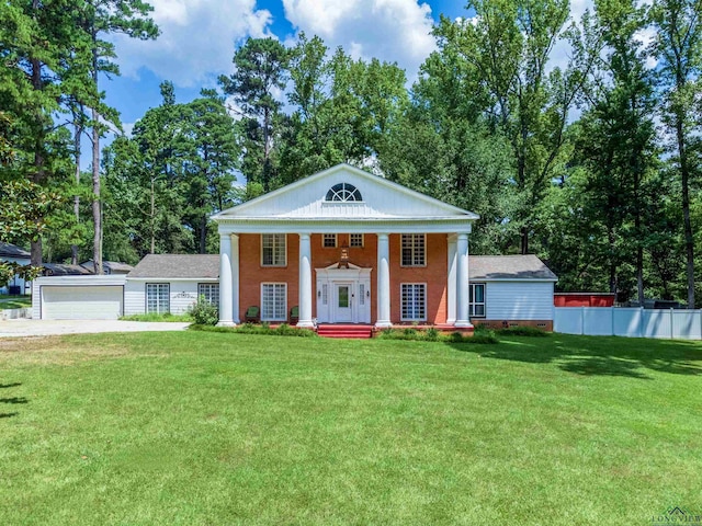 greek revival inspired property with a garage, an outdoor structure, and a front lawn