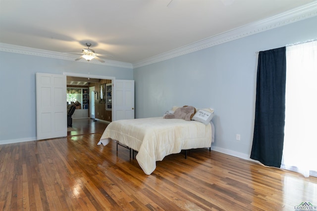 bedroom featuring ceiling fan, dark hardwood / wood-style flooring, and crown molding