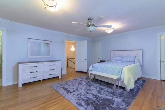 bedroom with hardwood / wood-style floors, ceiling fan, and crown molding