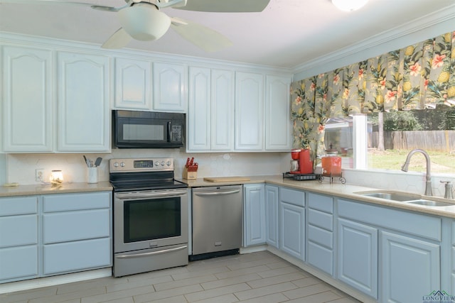 kitchen featuring white cabinets, stainless steel appliances, ornamental molding, and sink