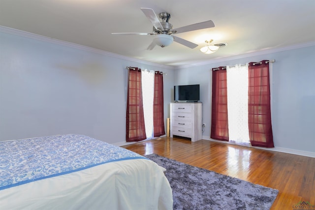 bedroom featuring ceiling fan, hardwood / wood-style floors, and crown molding