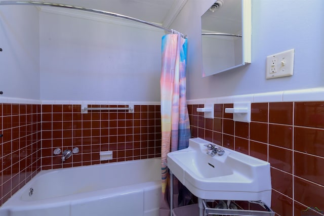 bathroom with sink, tile walls, and ornamental molding