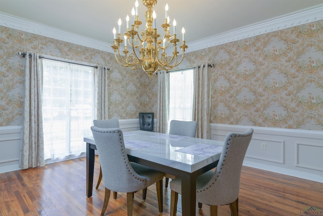 dining space featuring a healthy amount of sunlight, dark hardwood / wood-style floors, an inviting chandelier, and ornamental molding