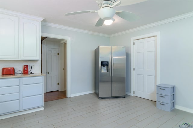 kitchen featuring stainless steel fridge with ice dispenser, crown molding, and white cabinets