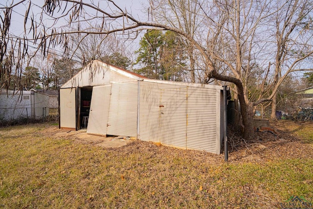 view of outbuilding with fence and an outbuilding