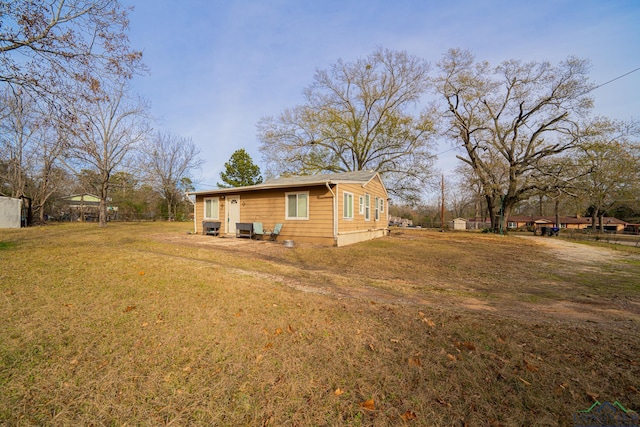 view of property exterior featuring a lawn