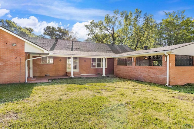 back of house featuring a yard