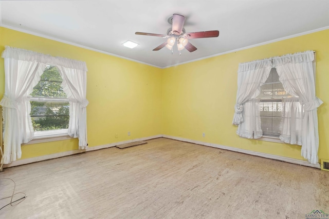 unfurnished room featuring ceiling fan and crown molding