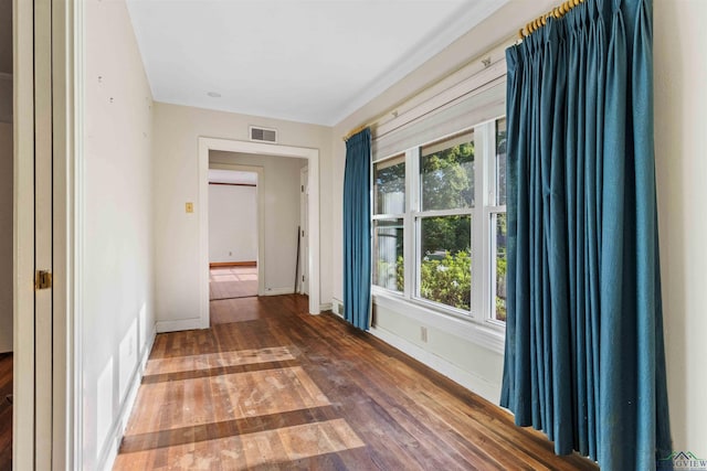 spare room with hardwood / wood-style flooring and a healthy amount of sunlight