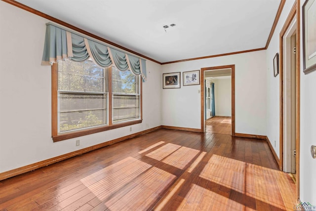 spare room with dark hardwood / wood-style flooring and ornamental molding