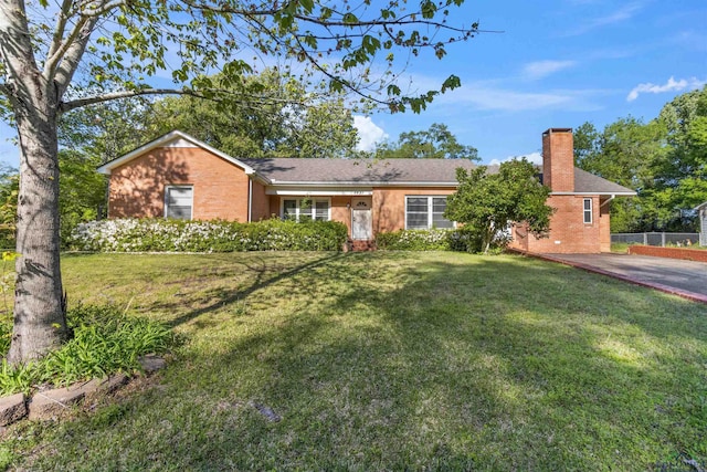 ranch-style home with a front lawn