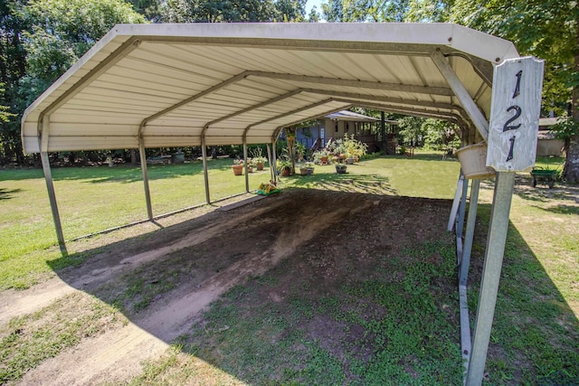 view of parking featuring a yard and a carport