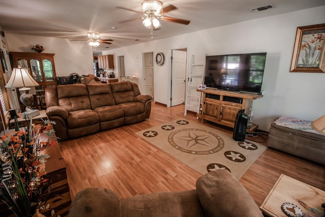 living room with ceiling fan and hardwood / wood-style floors