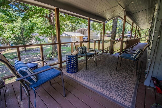 unfurnished sunroom with a healthy amount of sunlight and wood ceiling