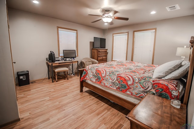 bedroom with ceiling fan and light wood-type flooring