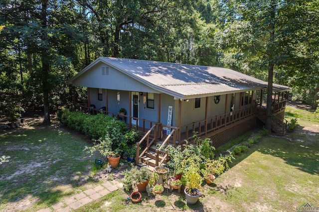 view of front of home with a front yard and a porch