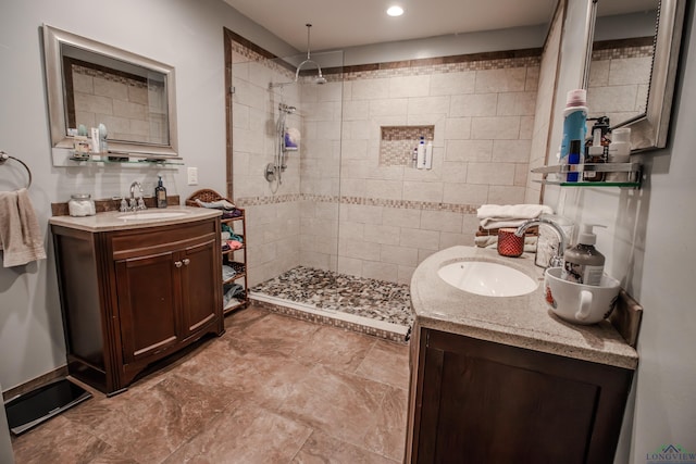 bathroom featuring vanity and tiled shower