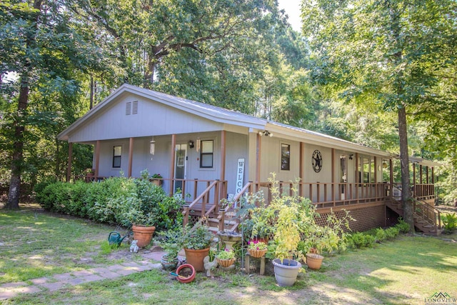 view of front of home featuring covered porch and a front yard