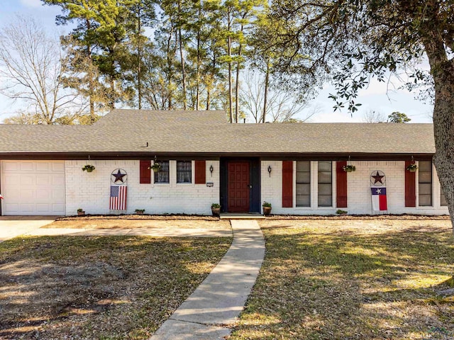 single story home with a garage and a front yard