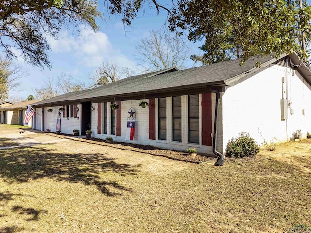 ranch-style home featuring a front yard and a garage