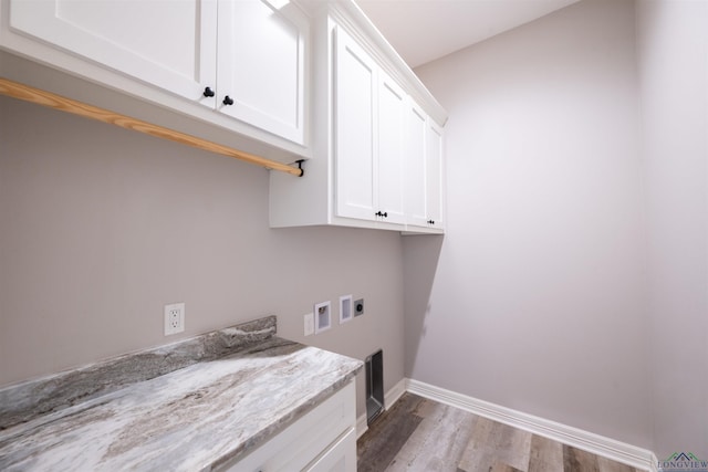 laundry area featuring hookup for a washing machine, cabinets, light wood-type flooring, and hookup for an electric dryer