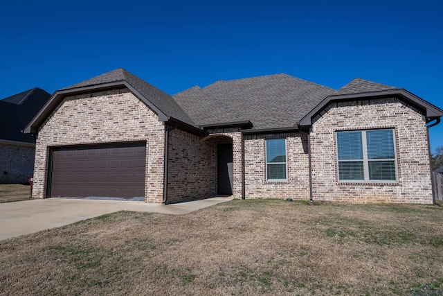 view of front of home with a front lawn and a garage