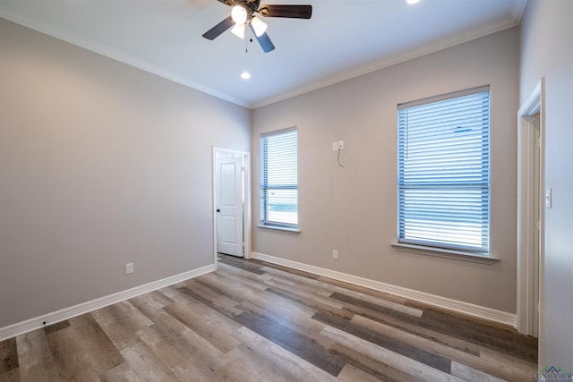 spare room featuring hardwood / wood-style flooring, ceiling fan, and ornamental molding