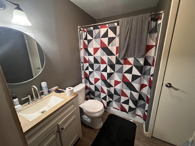 bathroom with walk in shower, vanity, toilet, and hardwood / wood-style floors