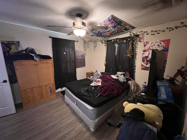 bedroom featuring hardwood / wood-style floors and ceiling fan