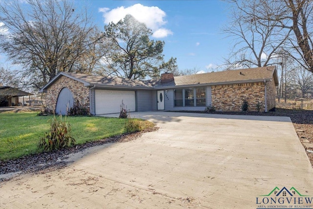 ranch-style home featuring a garage and a front yard