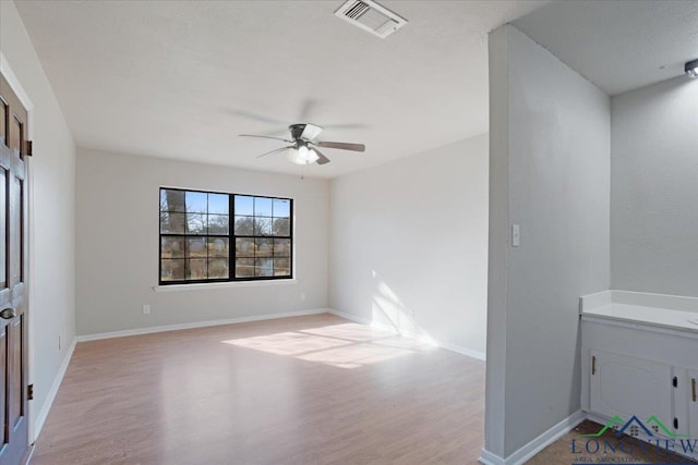 spare room with ceiling fan and light hardwood / wood-style floors