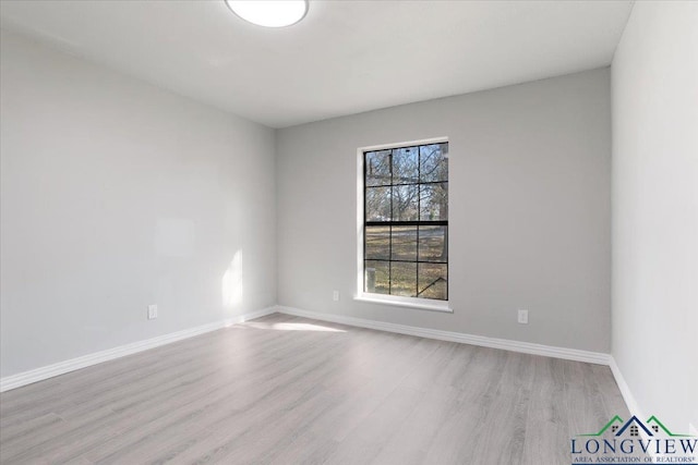 unfurnished room with light wood-type flooring