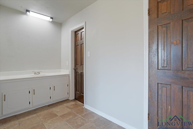 bathroom featuring tile patterned flooring and sink