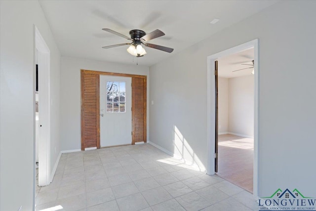 entrance foyer with ceiling fan