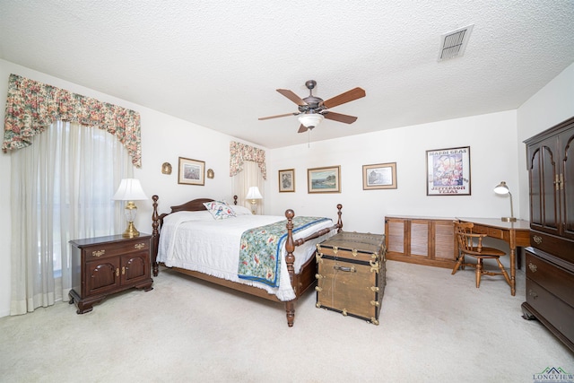 carpeted bedroom with a textured ceiling and ceiling fan