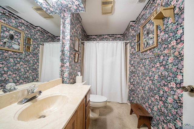 bathroom with vanity, toilet, and walk in shower