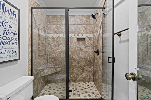 bathroom with toilet, an enclosed shower, and crown molding