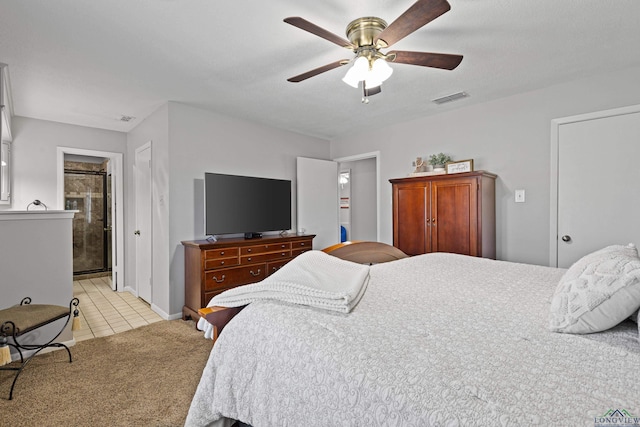 carpeted bedroom with ceiling fan and connected bathroom