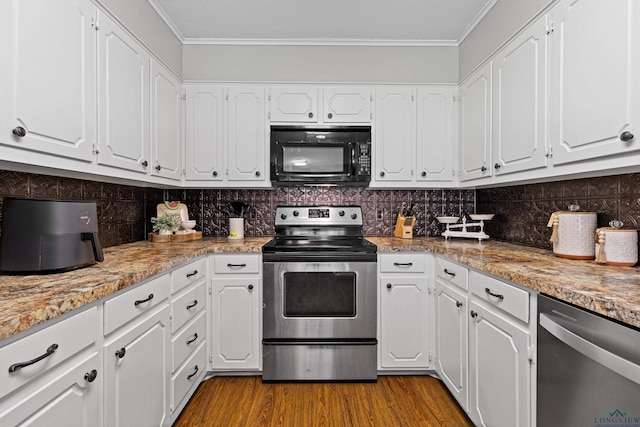 kitchen featuring white cabinets, stainless steel appliances, light stone countertops, and light hardwood / wood-style floors