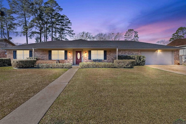 ranch-style home with a lawn and a garage