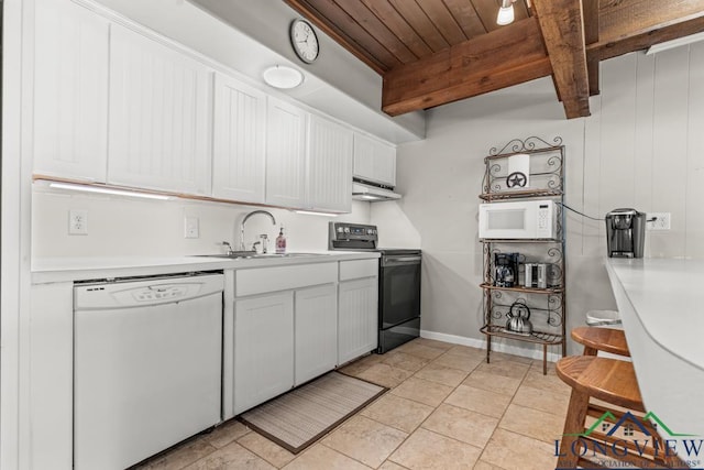 620 Shadywood Ln, Avinger, TX 75630 - kitchen with white appliances, under cabinet range hood, light countertops, white cabinets, and a wooden ceiling with exposed beams